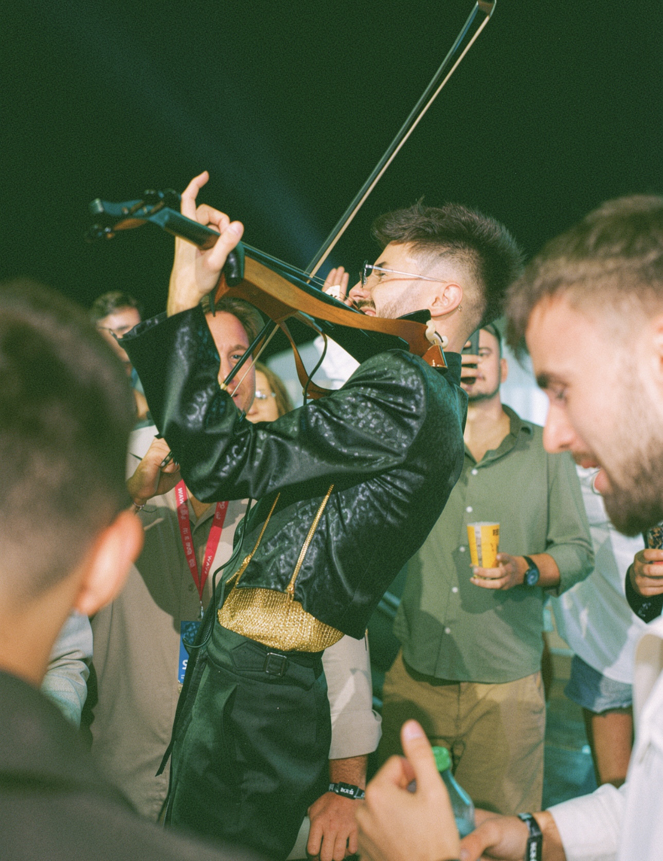 Máté Kozma performing electric violin in a crowd