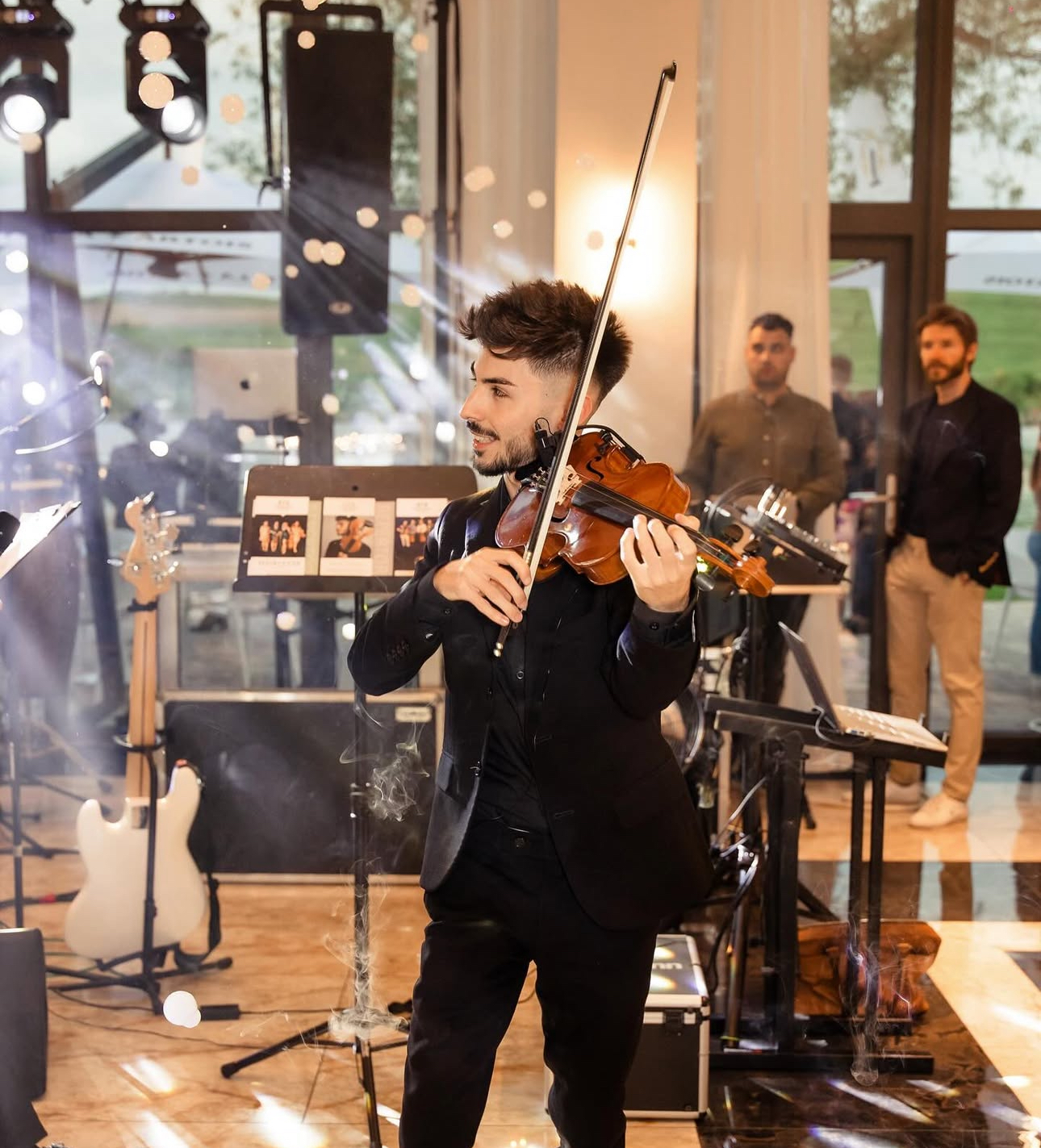 Máté Kozma performing at a luxury event with sparklers and stage lights